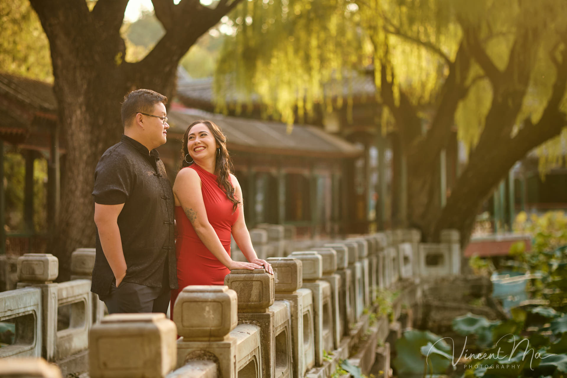 A couple enjoying an engagement photoshoot at the Summer Palace in Beijing, with traditional Chinese architecture and gardens in the background. Captured by a local Beijing photographer.