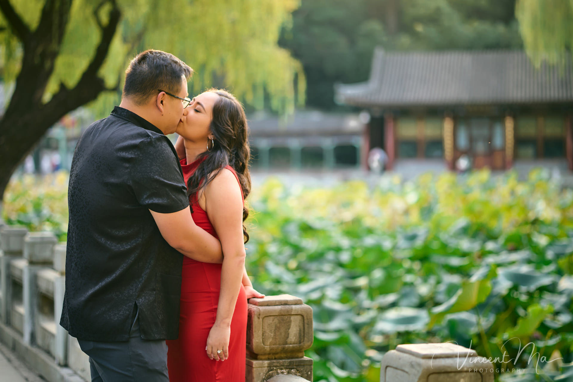 A couple enjoying an engagement photoshoot at the Summer Palace in Beijing, with traditional Chinese architecture and gardens in the background. Captured by a local Beijing photographer.