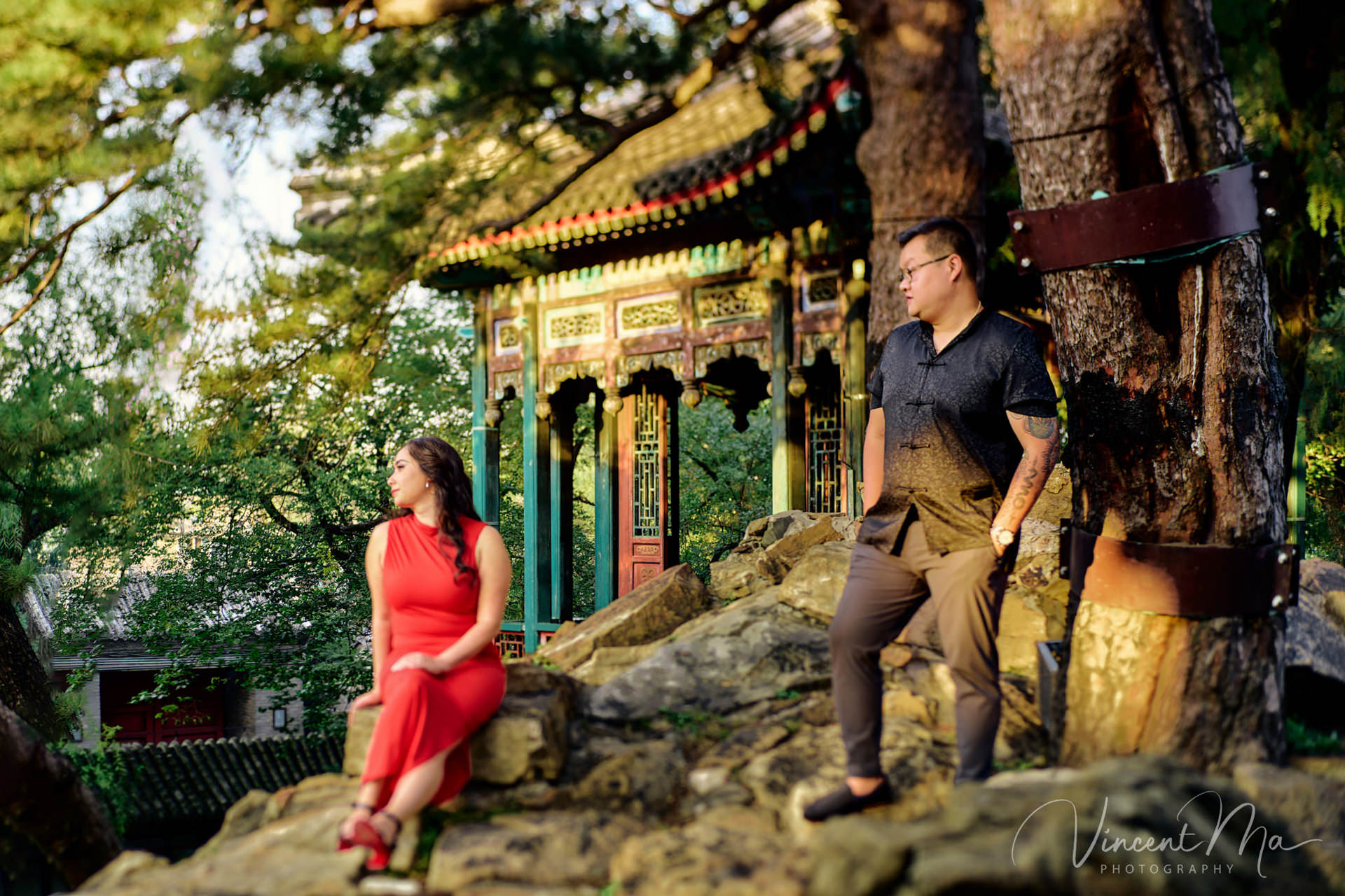 A couple enjoying an engagement photoshoot at the Summer Palace in Beijing, with traditional Chinese architecture and gardens in the background. Captured by a local Beijing photographer.