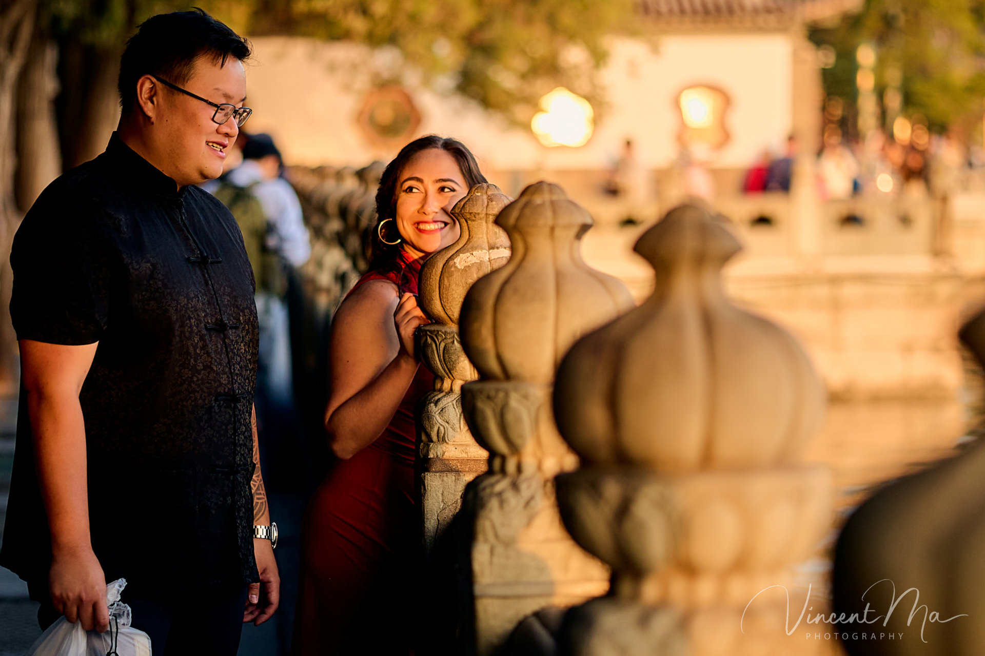 A couple enjoying an engagement photoshoot at the Summer Palace in Beijing, with traditional Chinese architecture and gardens in the background. Captured by a local Beijing photographer.