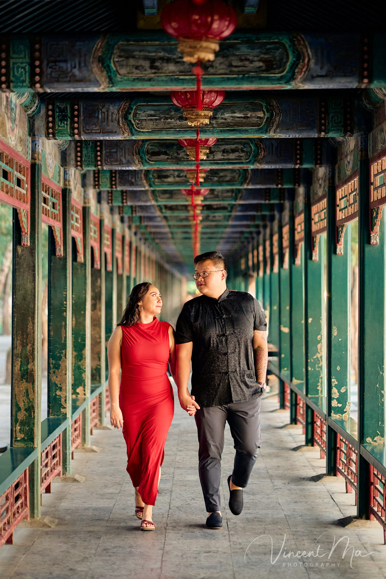 A couple enjoying an engagement photoshoot at the Summer Palace in Beijing, with traditional Chinese architecture and gardens in the background. Captured by a local Beijing photographer.