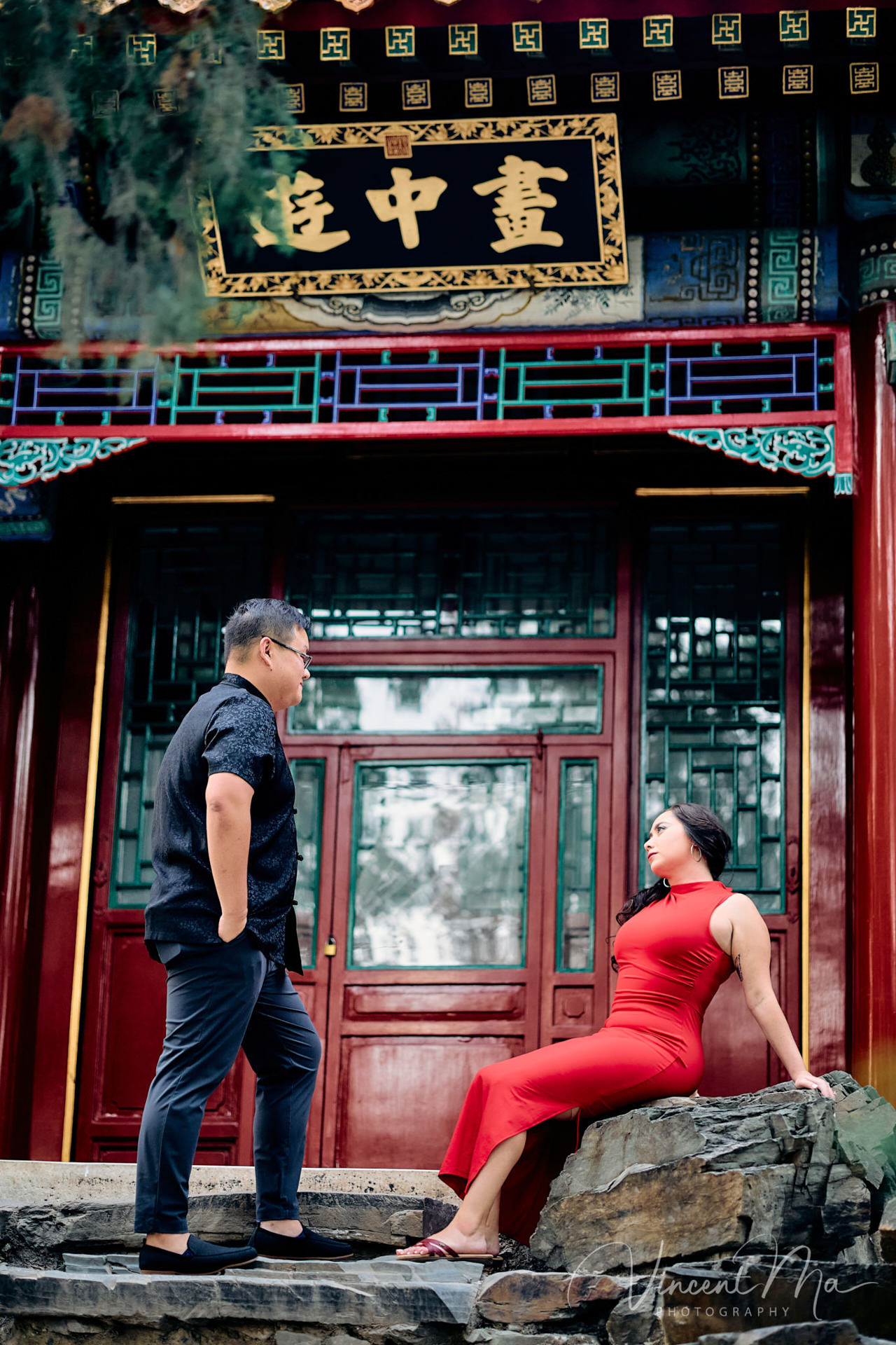 A couple enjoying an engagement photoshoot at the Summer Palace in Beijing, with traditional Chinese architecture and gardens in the background. Captured by a local Beijing photographer.