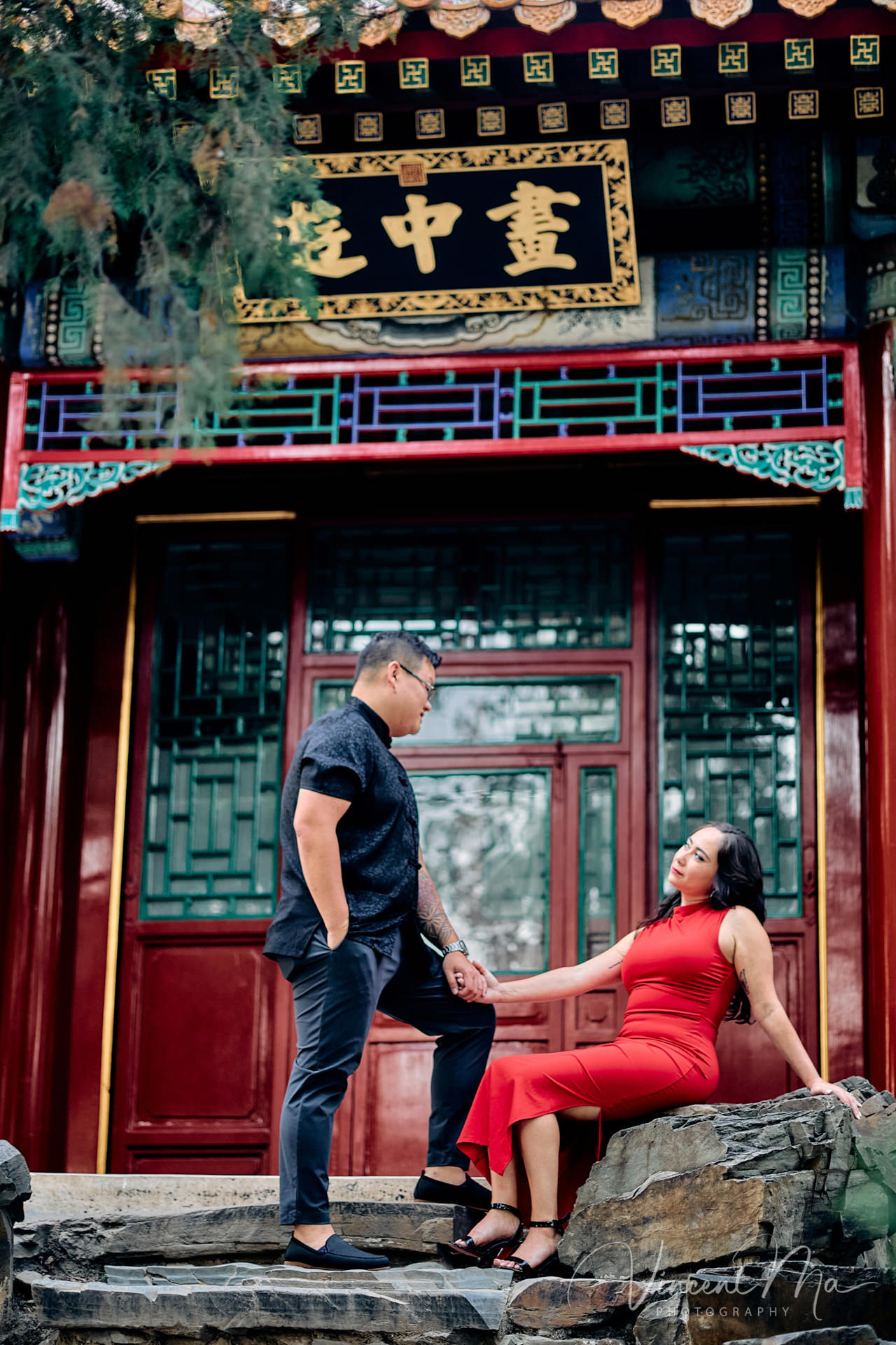 A couple enjoying an engagement photoshoot at the Summer Palace in Beijing, with traditional Chinese architecture and gardens in the background. Captured by a local Beijing photographer.