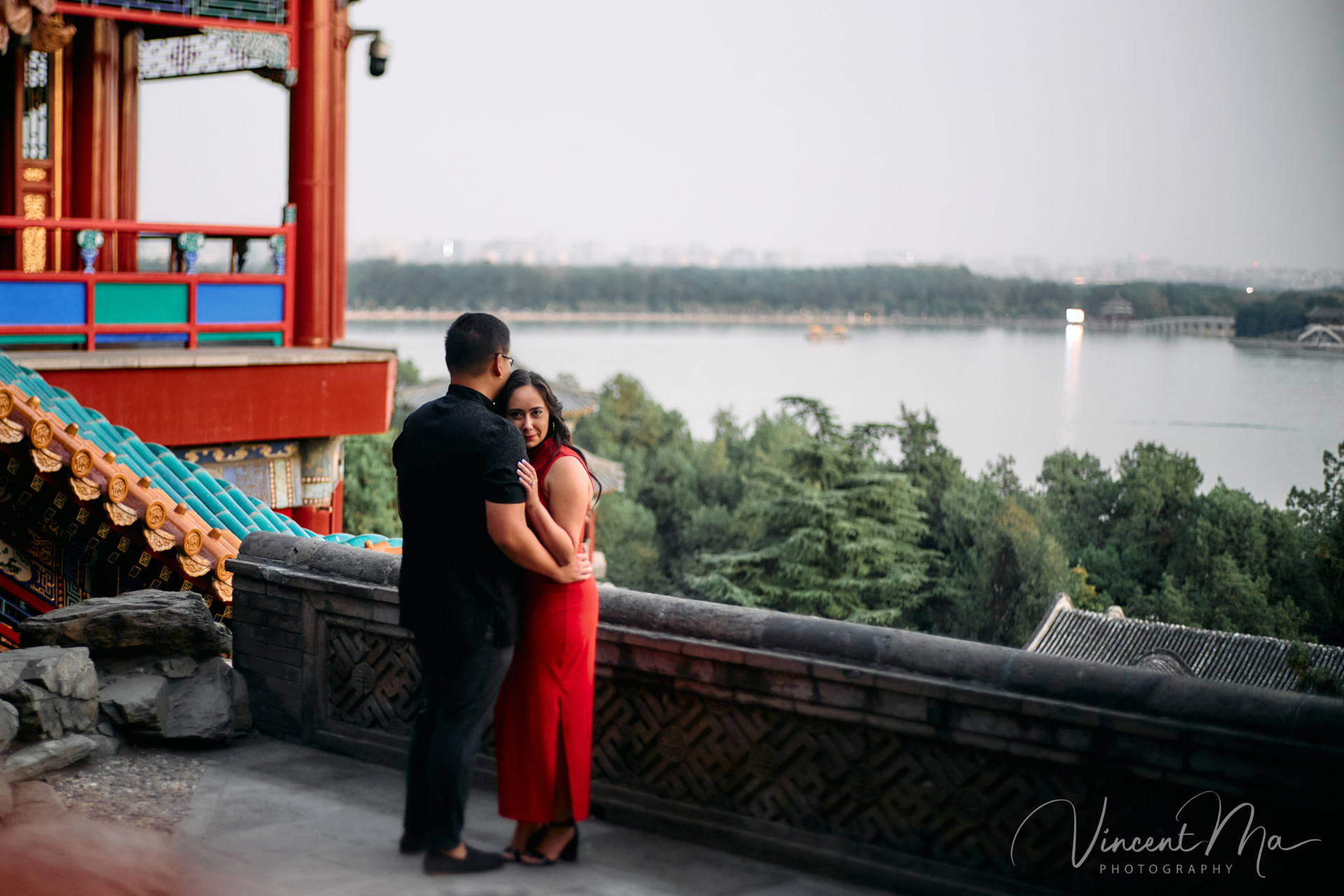 A couple enjoying an engagement photoshoot at the Summer Palace in Beijing, with traditional Chinese architecture and gardens in the background. Captured by a local Beijing photographer.