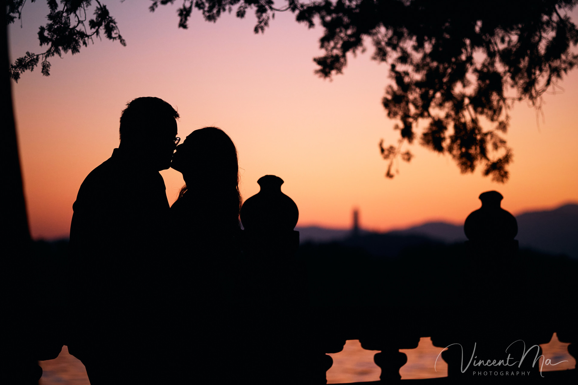 A couple enjoying an engagement photoshoot at the Summer Palace in Beijing, with traditional Chinese architecture and gardens in the background. Captured by a local Beijing photographer.