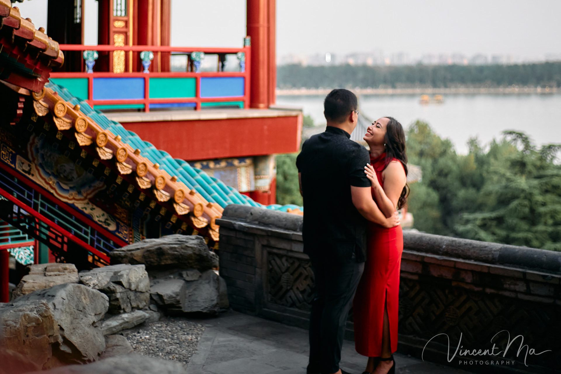 A couple enjoying an engagement photoshoot at the Summer Palace in Beijing, with traditional Chinese architecture and gardens in the background. Captured by a local Beijing photographer.