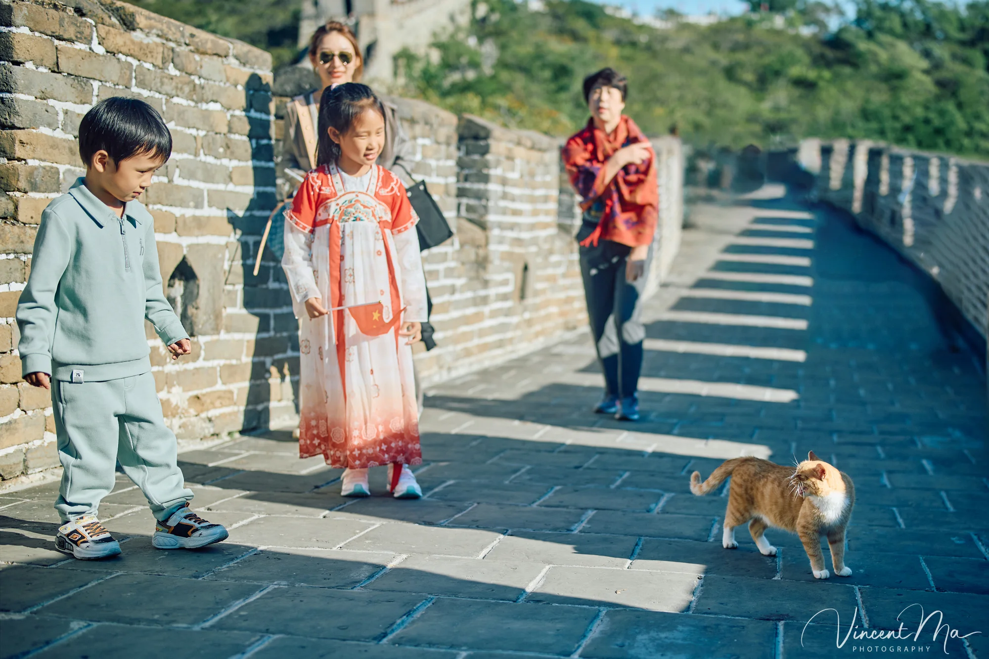 A panoramic view of the Mutianyu Great Wall during a family trip in the afternoon, showing the majestic wall winding through the mountains