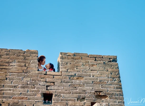 A panoramic view of the Mutianyu Great Wall during a family trip in the afternoon, showing the majestic wall winding through the mountains