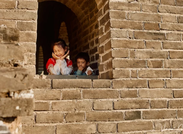 A panoramic view of the Mutianyu Great Wall during a family trip in the afternoon, showing the majestic wall winding through the mountains