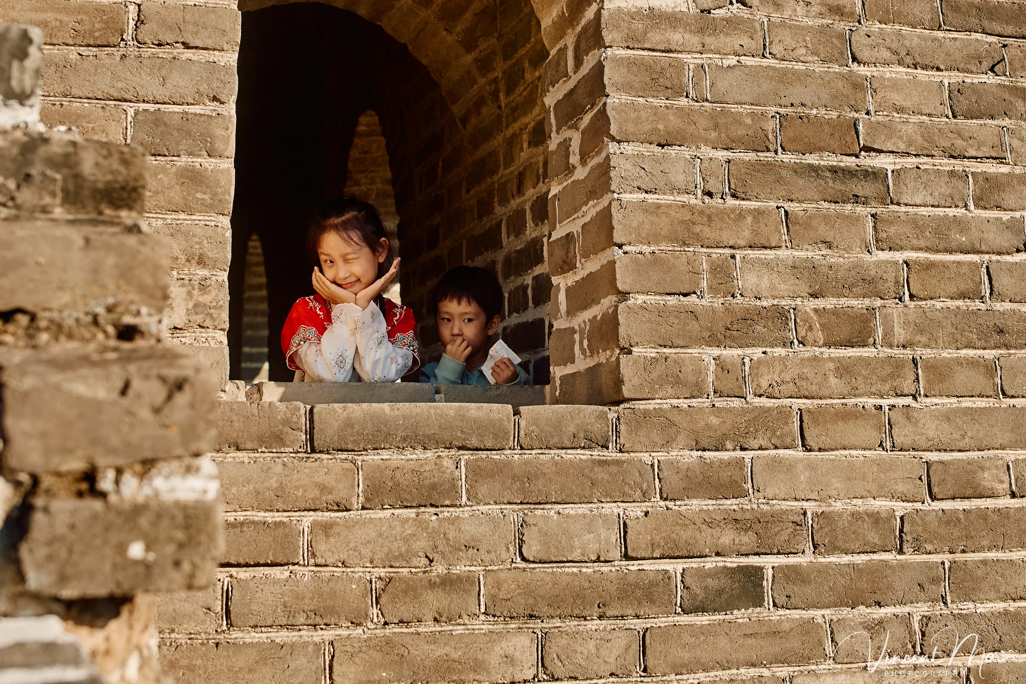A panoramic view of the Mutianyu Great Wall during a family trip in the afternoon, showing the majestic wall winding through the mountains