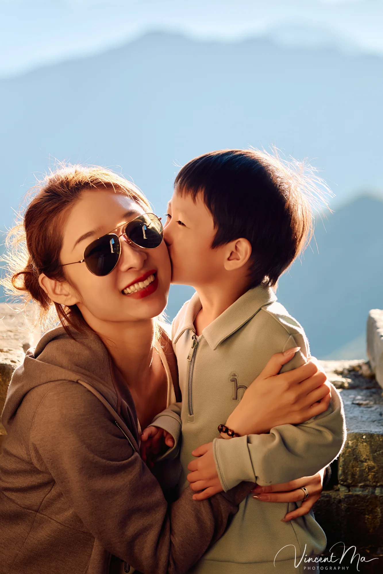 A panoramic view of the Mutianyu Great Wall during a family trip in the afternoon, showing the majestic wall winding through the mountains