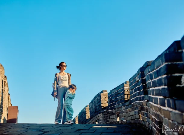 A panoramic view of the Mutianyu Great Wall during a family trip in the afternoon, showing the majestic wall winding through the mountains