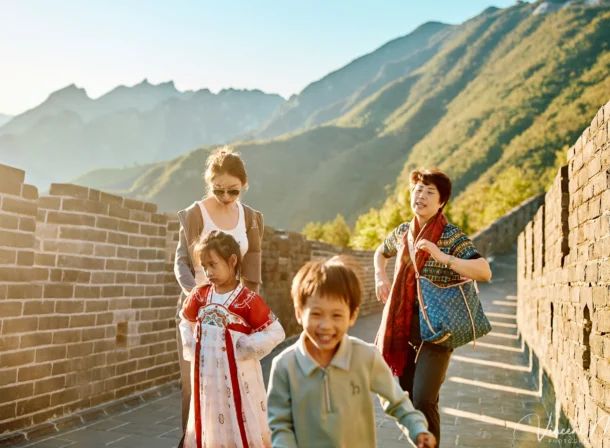 A panoramic view of the Mutianyu Great Wall during a family trip in the afternoon, showing the majestic wall winding through the mountains