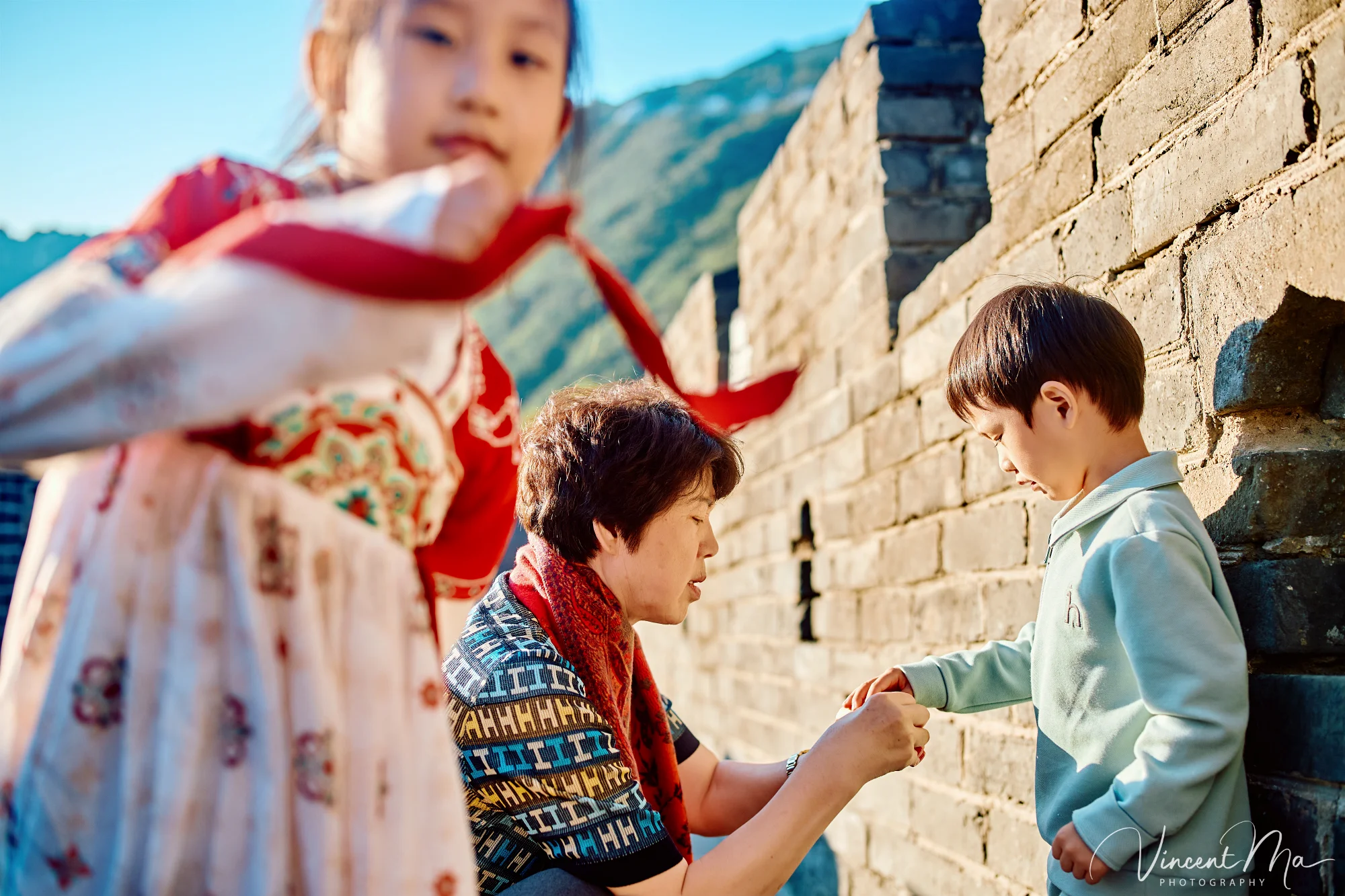 A panoramic view of the Mutianyu Great Wall during a family trip in the afternoon, showing the majestic wall winding through the mountains
