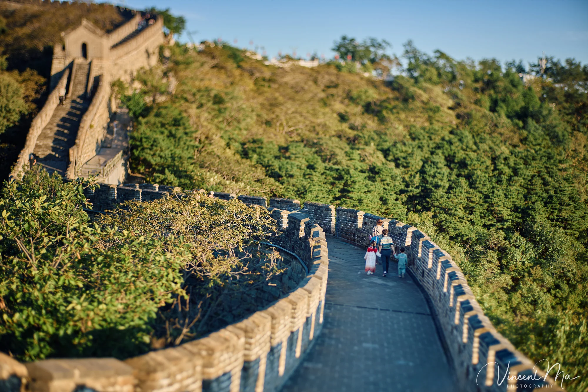 A panoramic view of the Mutianyu Great Wall during a family trip in the afternoon, showing the majestic wall winding through the mountains