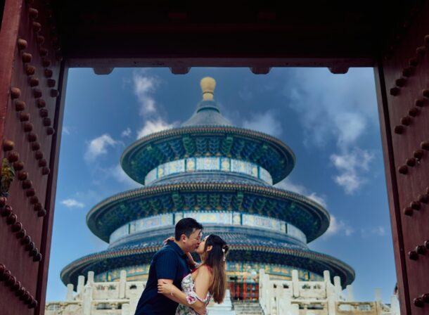 A foreign couple in traditional Chinese - style clothing, the man kneeling on one knee to propose to the woman in front of the majestic Hall of Prayer for Good Harvests in the Temple of Heaven