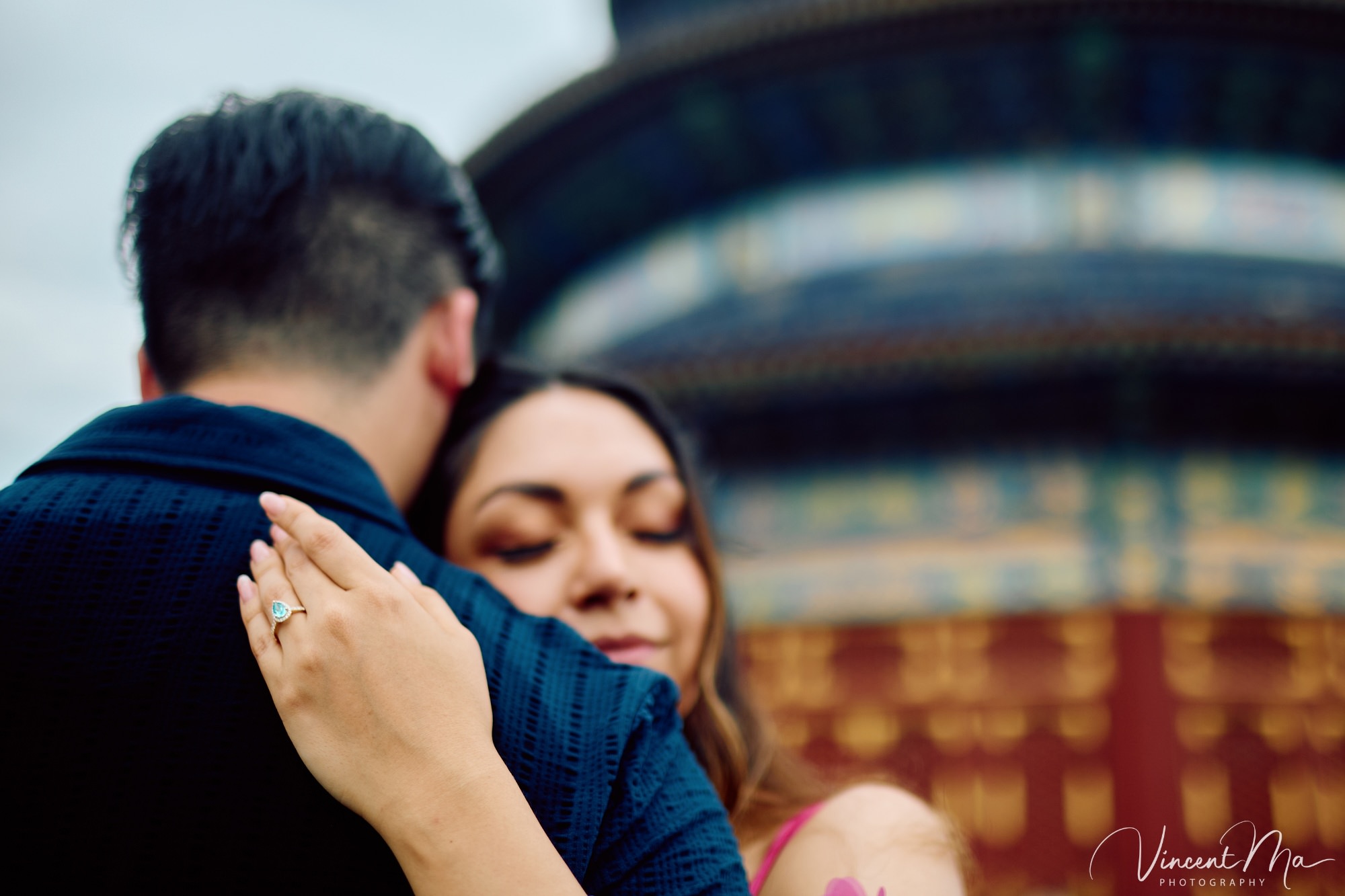 A foreign couple in traditional Chinese - style clothing, the man kneeling on one knee to propose to the woman in front of the majestic Hall of Prayer for Good Harvests in the Temple of Heaven