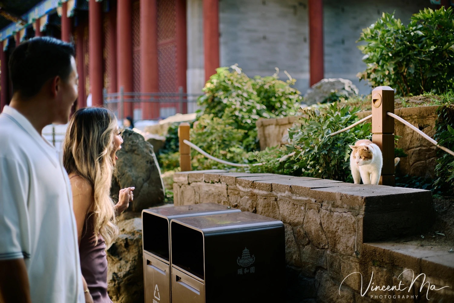 Couple enjoying a romantic moment at the Garden of Harmonious Interests in Beijing's Summer Palace, surrounded by traditional Chinese garden scenery with lakes and pavilions. Engagement shooting in summer palace.