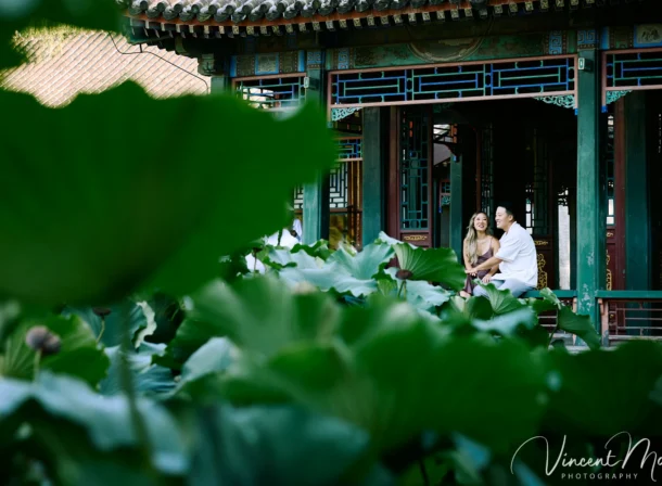 Couple enjoying a romantic moment at the Garden of Harmonious Interests in Beijing's Summer Palace, surrounded by traditional Chinese garden scenery with lakes and pavilions. Engagement shooting in summer palace.