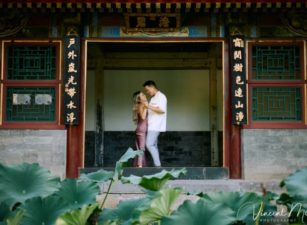 Couple enjoying a romantic moment at the Garden of Harmonious Interests in Beijing's Summer Palace, surrounded by traditional Chinese garden scenery with lakes and pavilions. Engagement shooting in summer palace.