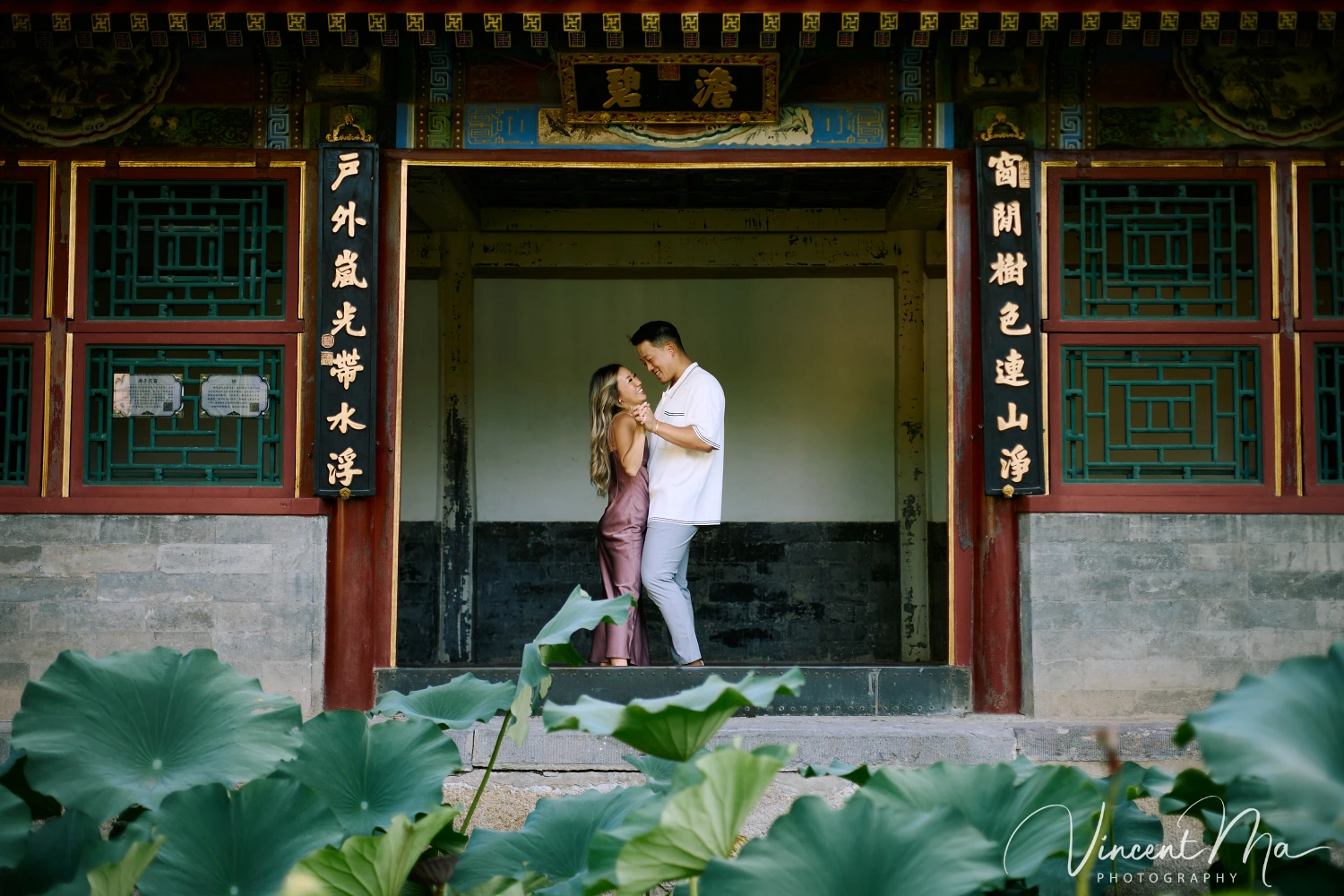 Couple enjoying a romantic moment at the Garden of Harmonious Interests in Beijing's Summer Palace, surrounded by traditional Chinese garden scenery with lakes and pavilions. Engagement shooting in summer palace.