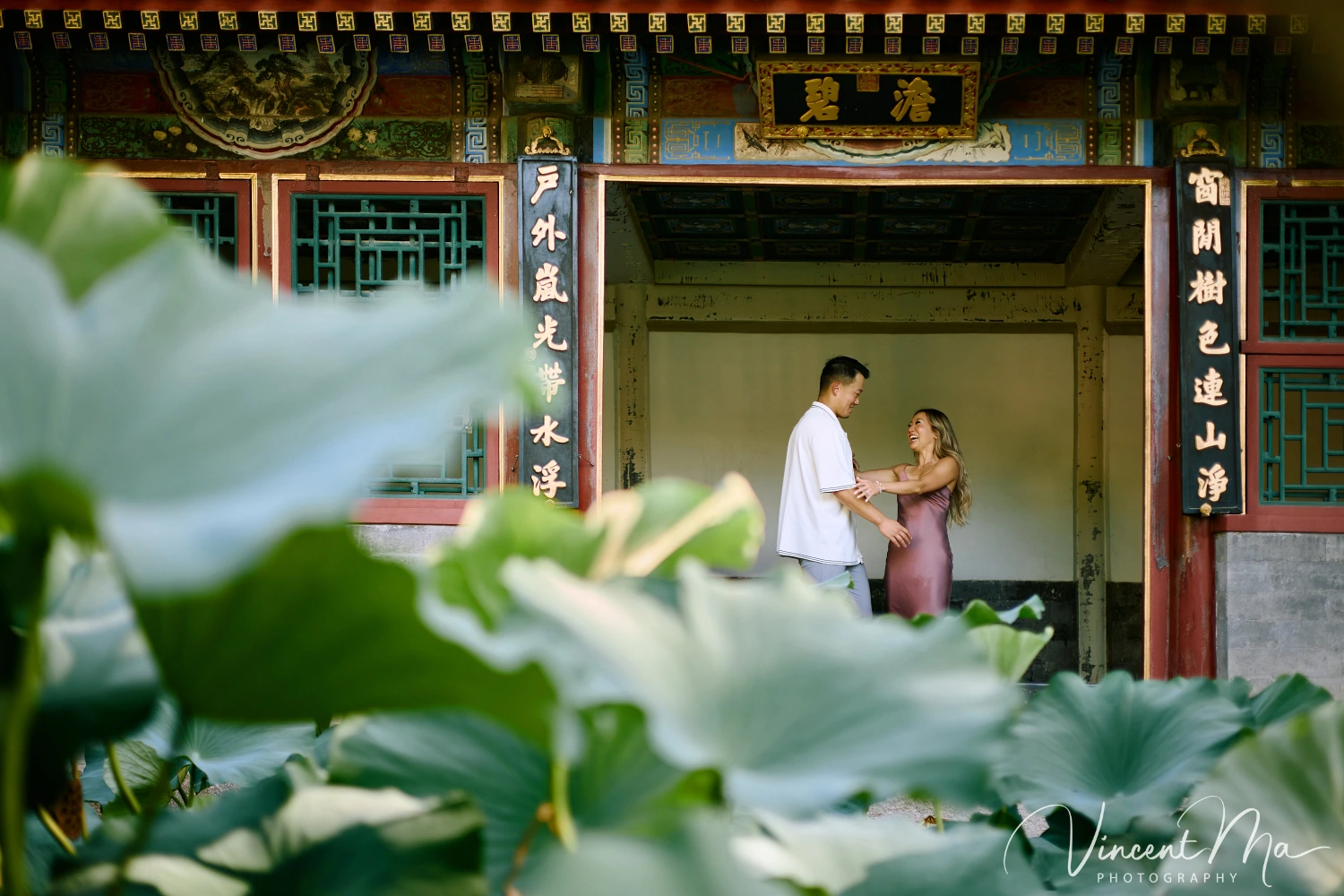 Couple enjoying a romantic moment at the Garden of Harmonious Interests in Beijing's Summer Palace, surrounded by traditional Chinese garden scenery with lakes and pavilions. Engagement shooting in summer palace.