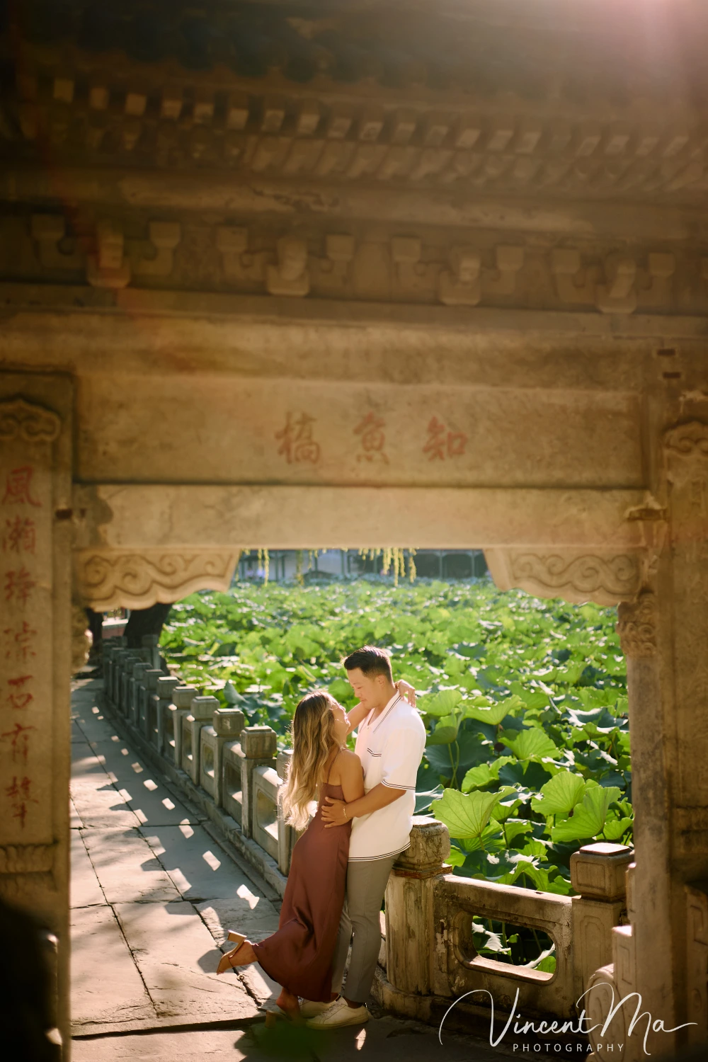 Couple enjoying a romantic moment at the Garden of Harmonious Interests in Beijing's Summer Palace, surrounded by traditional Chinese garden scenery with lakes and pavilions. Engagement shooting in summer palace.