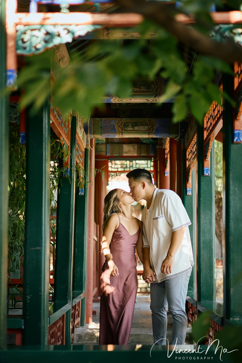 Couple enjoying a romantic moment at the Garden of Harmonious Interests in Beijing's Summer Palace, surrounded by traditional Chinese garden scenery with lakes and pavilions. Engagement shooting in summer palace.