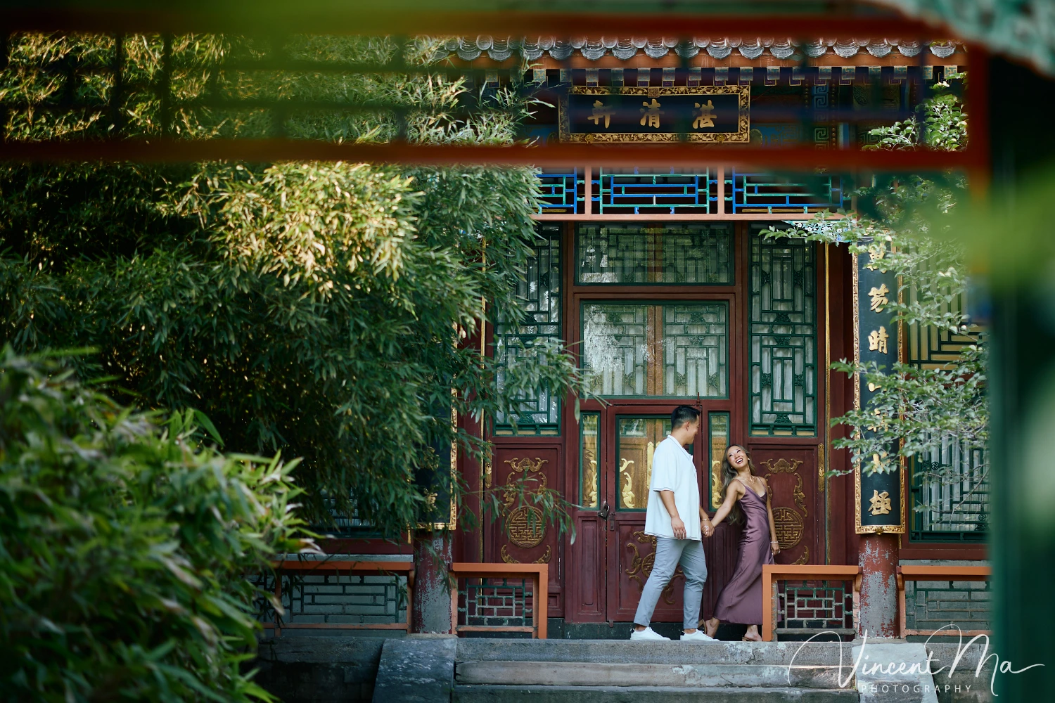 Couple enjoying a romantic moment at the Garden of Harmonious Interests in Beijing's Summer Palace, surrounded by traditional Chinese garden scenery with lakes and pavilions. Engagement shooting in summer palace.