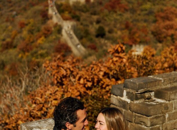 Surprise marriage proposal engagement shooting on Mutianyu Great Wall with ancient bricks and autumn leaves in background