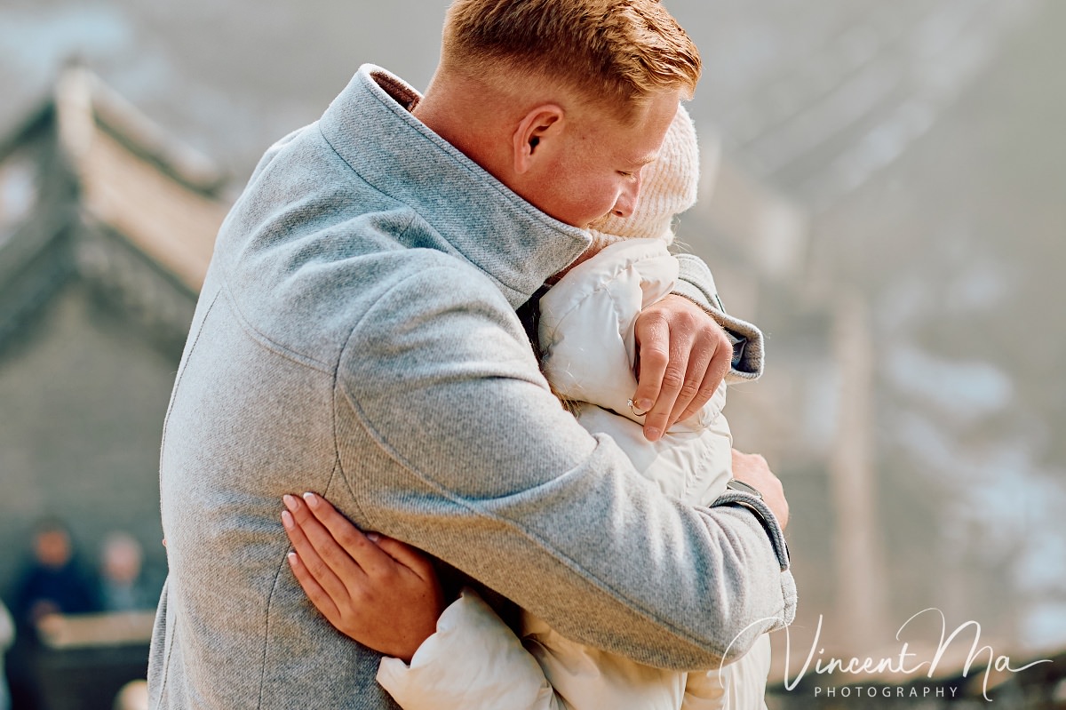South African couple proposal at Mutianyu Great Wall during first snow.